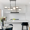 Modern kitchen with white countertops and black pendant light linear